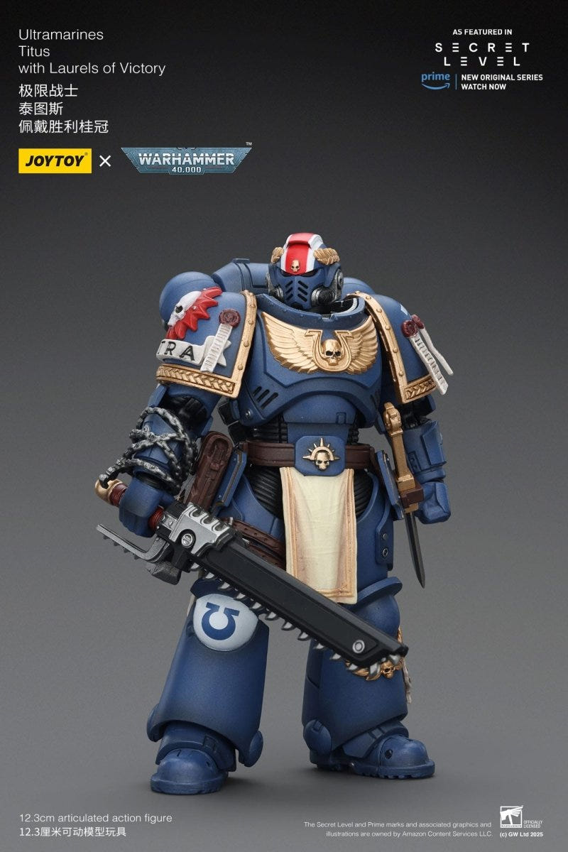 Joy Toy Ultramarines Titus figure front view holding chainsword, on grey backdrop