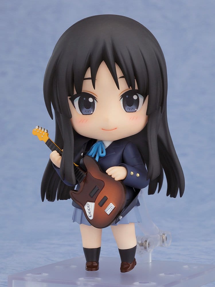 Nendoroid Mio Akiyama 2.0 on stand in school uniform, smiling with her bass