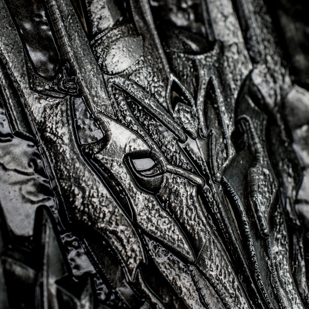 Macro detail of Sauron's spiked helmet sculpted on the reverse of the coin
