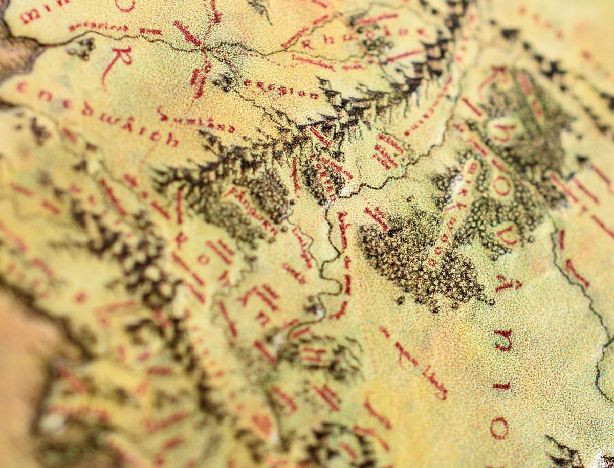 Close-up of printed mountains and forests on the Middle-earth map coin