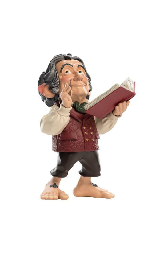 Weta Workshop Mini Epics Bilbo vinyl figure reading his red book with pipe in hand, full view