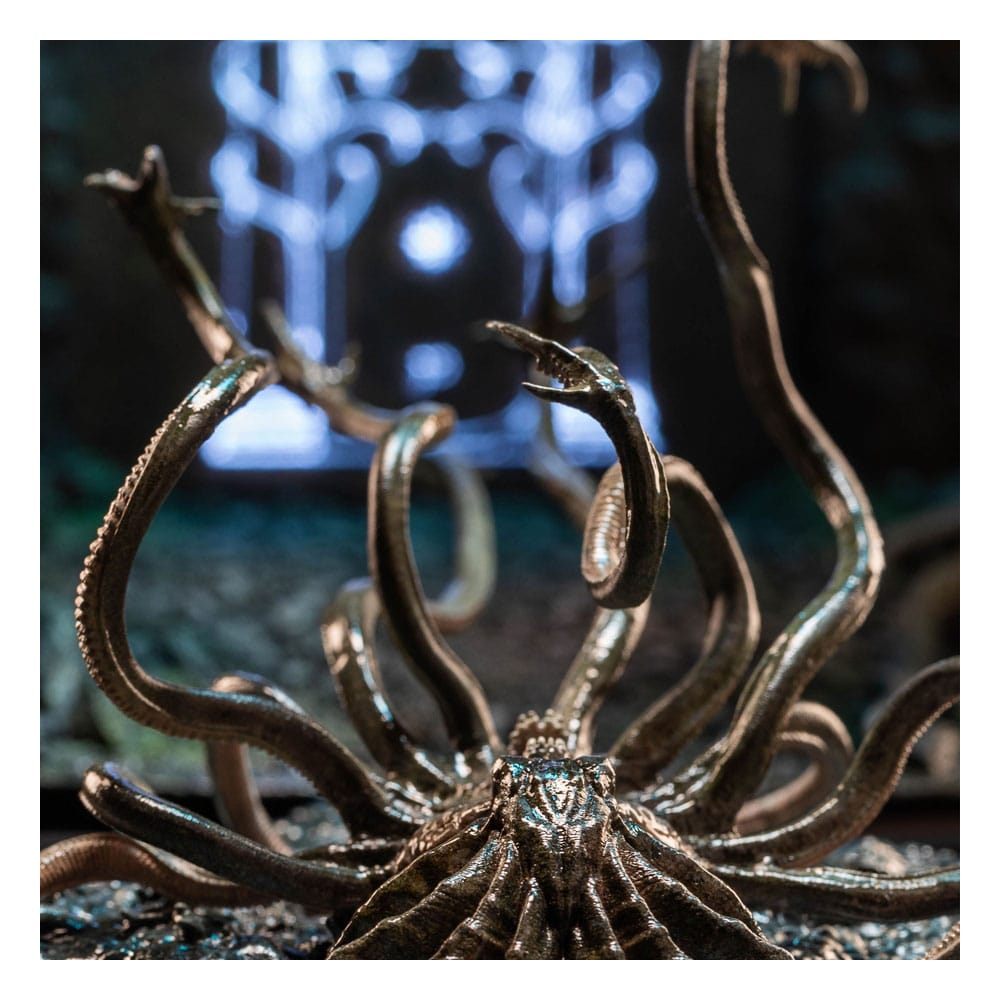 Weta Workshop Watcher in the Water mini statue lunging in front of a glowing blue gateway backdrop