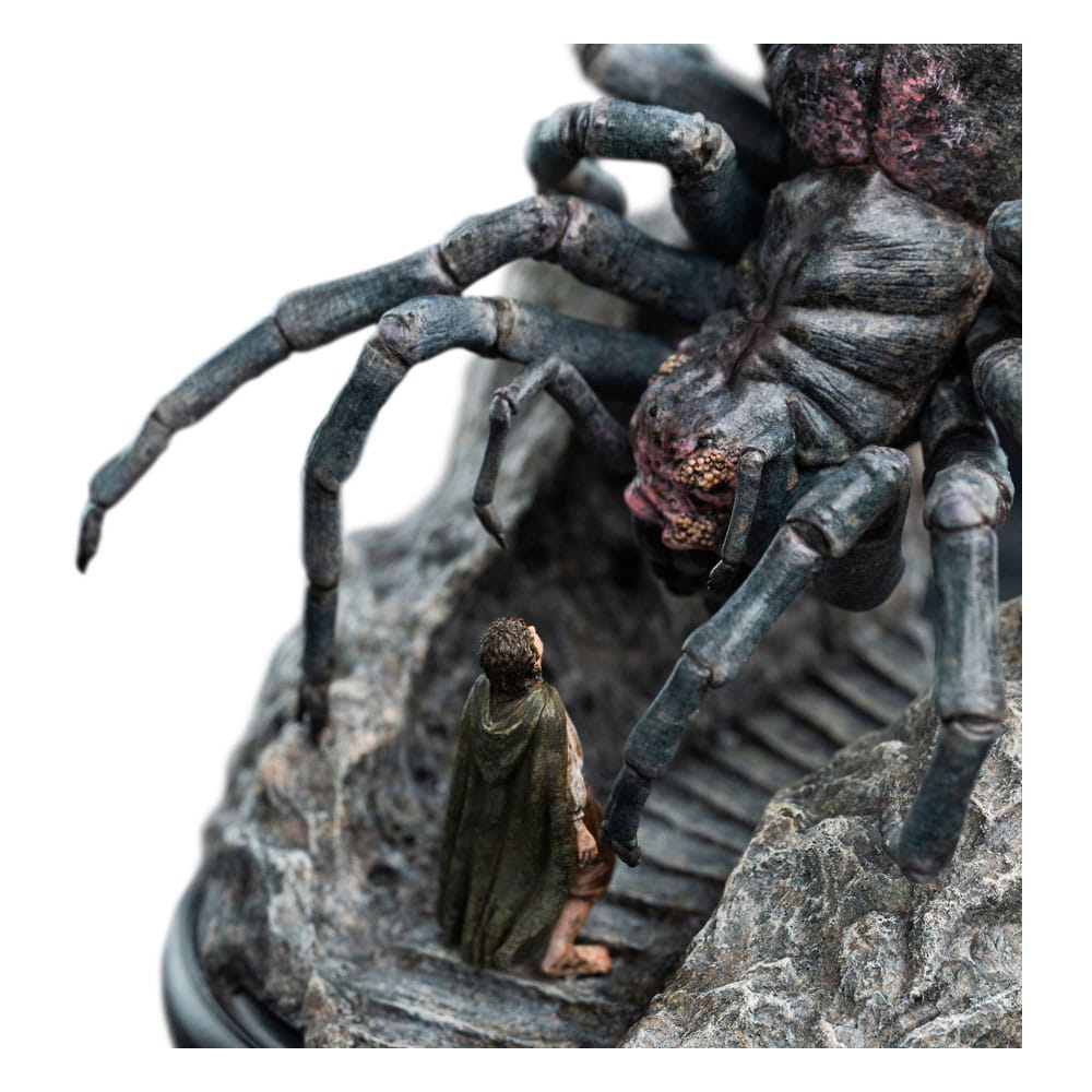 Close-up of the tiny cloaked hobbit on the stone stair beneath Shelob's legs