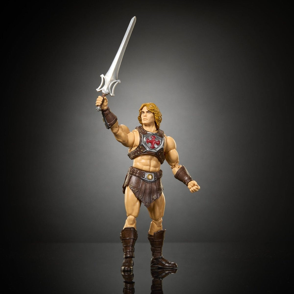 Mattel He-Man figure holding the power sword aloft in a classic heroic pose