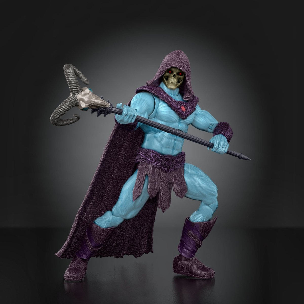 Skeletor 18cm figure in a wide battle stance wielding his ram-skull staff