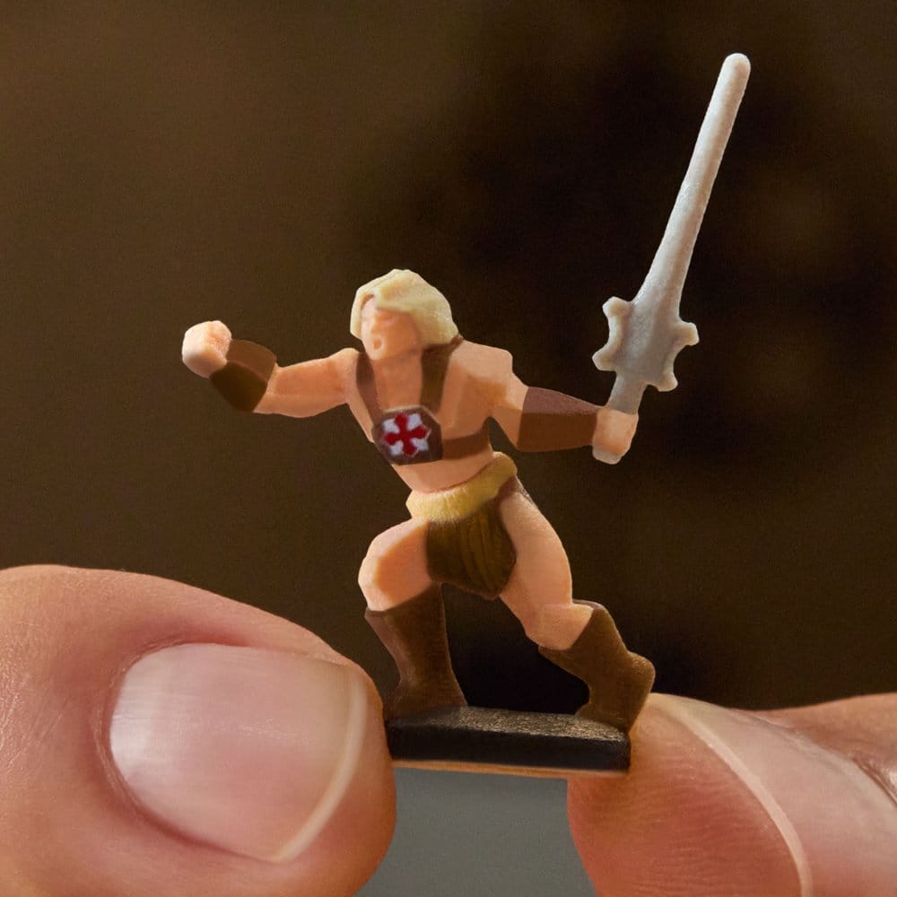 Close-up of a NanoWorld He-Man figure with sword held between fingers, Brick Shop Grayskull