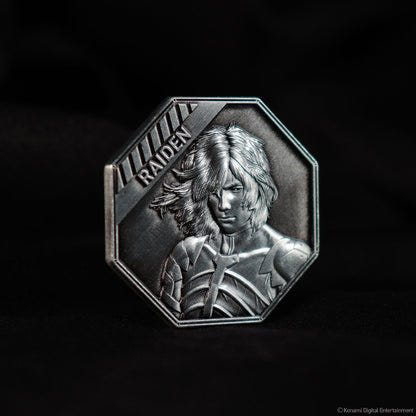 Metal Gear Solid 2 Raiden coin angled on a dark background, showing the raised portrait detail