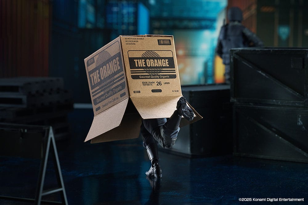 figma Solid Snake sneaking under The Orange cardboard box in a warehouse scene