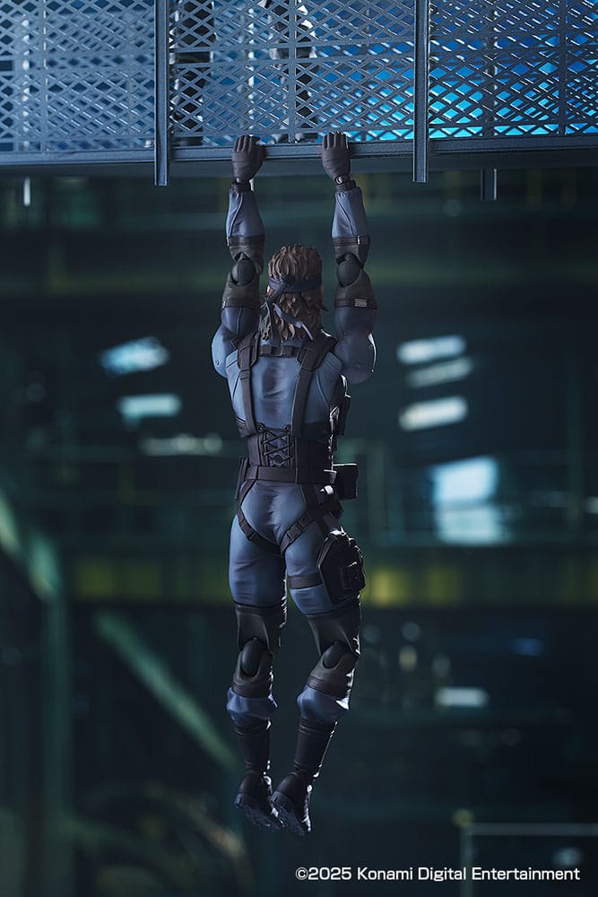figma Solid Snake hanging from a mesh walkway in a dark industrial scene