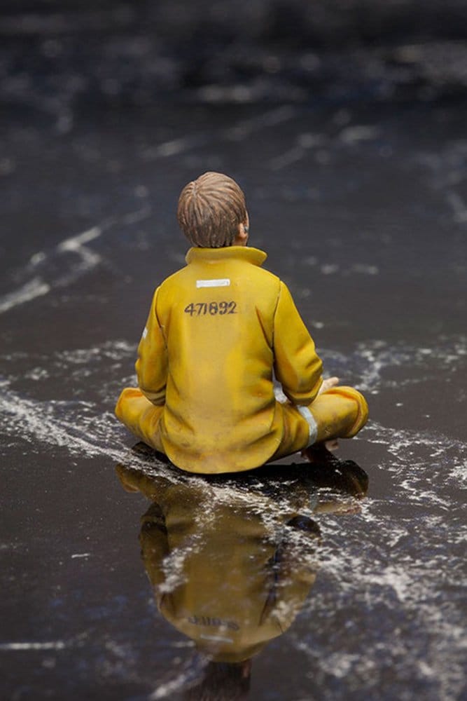 Ground Zero Set Chico figure rear view sitting in yellow prison clothes