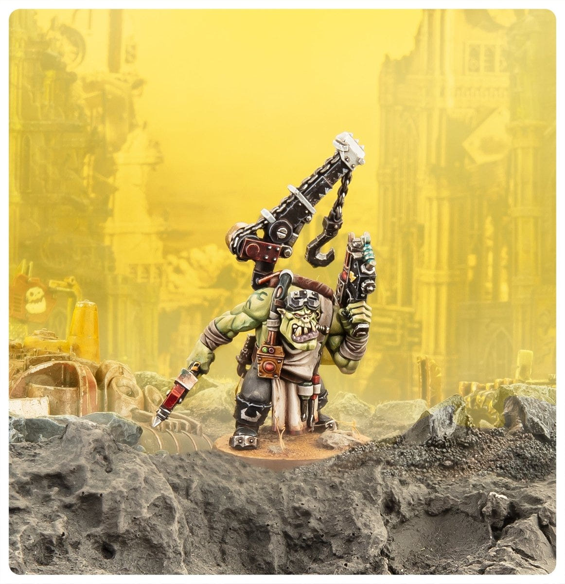 Painted Ork Mek standing on rubble against a yellow industrial backdrop