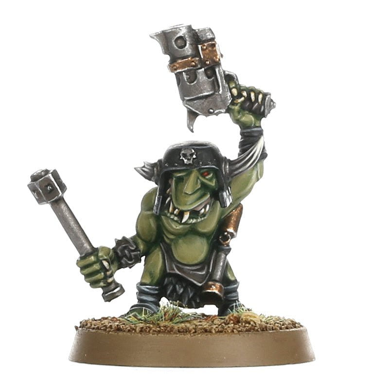 Painted Ork Runtherd close-up raising a metal mask, holding a hammer