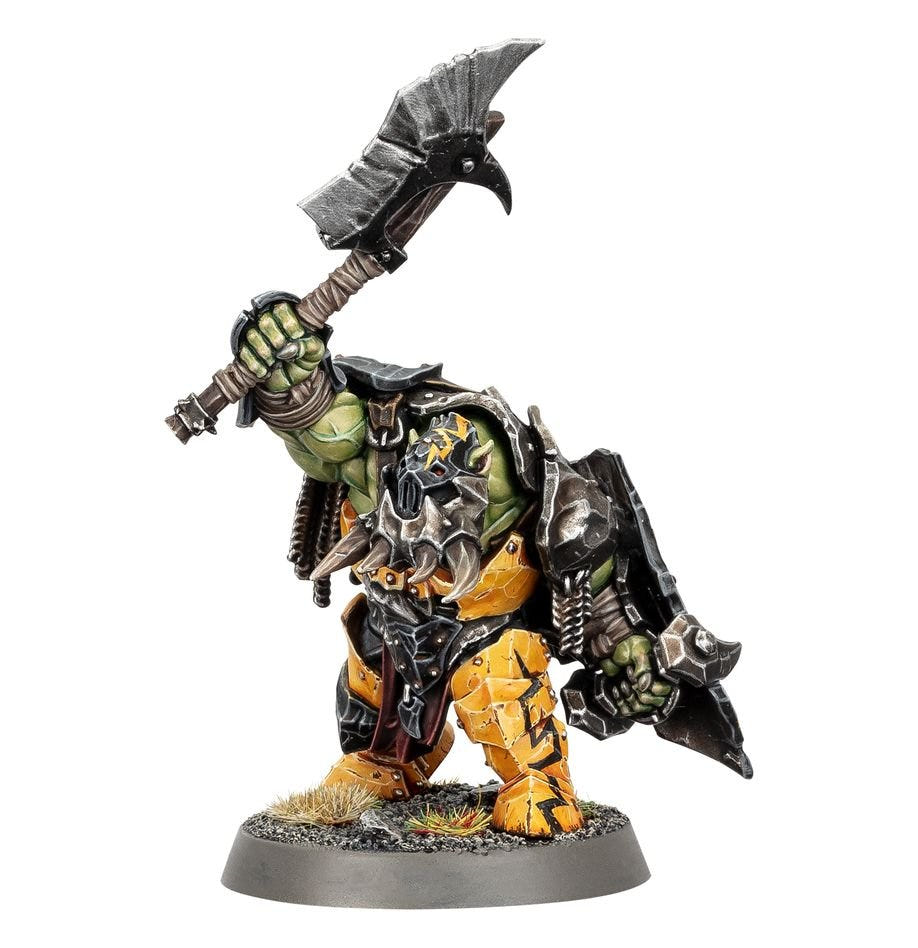 Painted Orruk Ardboy raising a heavy choppa with a shield, front view