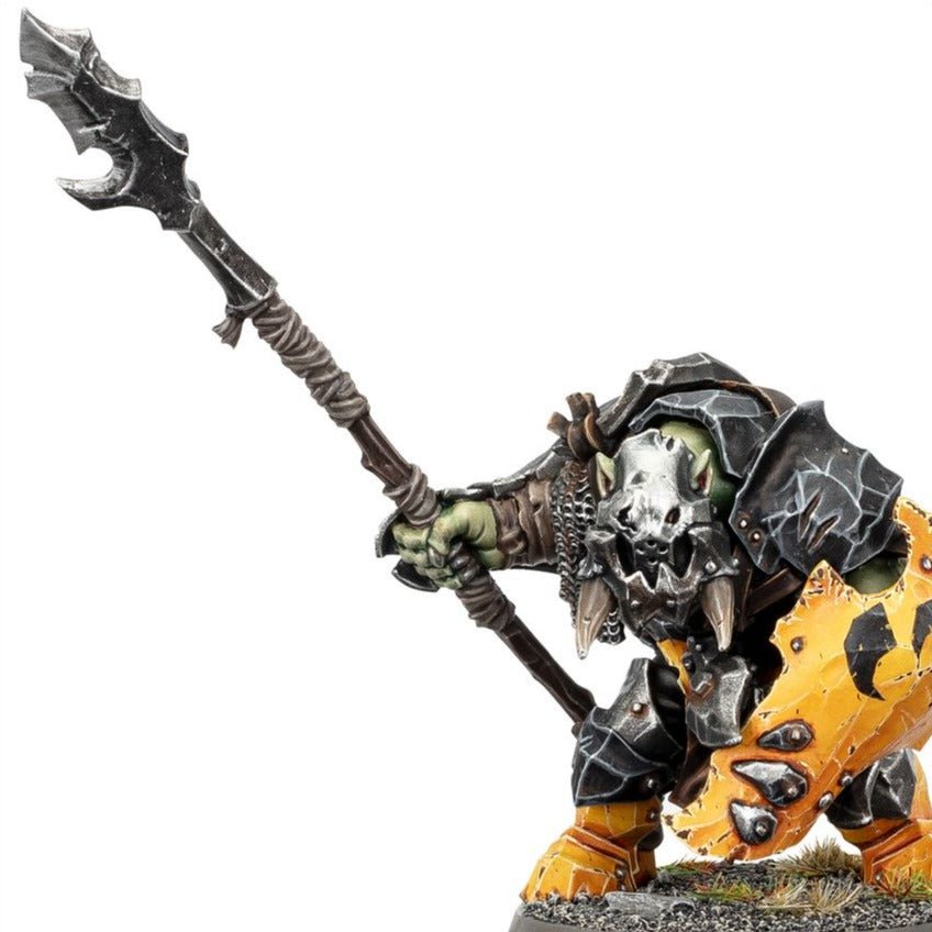 Close-up of a painted Orruk Ardboy holding a long stikka with a yellow shield