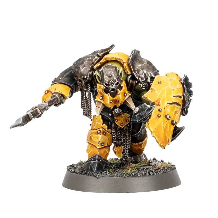 Painted Orruk Ardboy charging with a stikka behind a yellow shield
