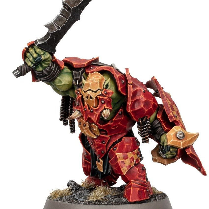 Painted Orruk Ardboy in red armour swinging a jagged choppa, alternative colour scheme