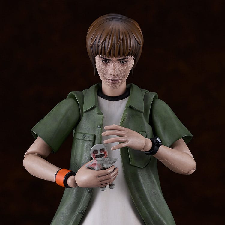 Close-up of Kyoya Suda Plamatea kit face and hands holding a small doll-like figure