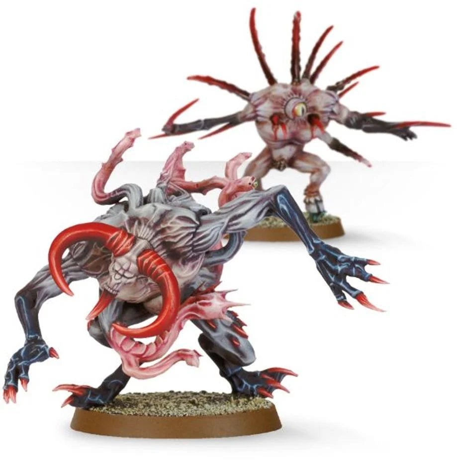 Two painted Chaos Spawn, a dark grey beast with red tentacles and a spiny pale spawn behind