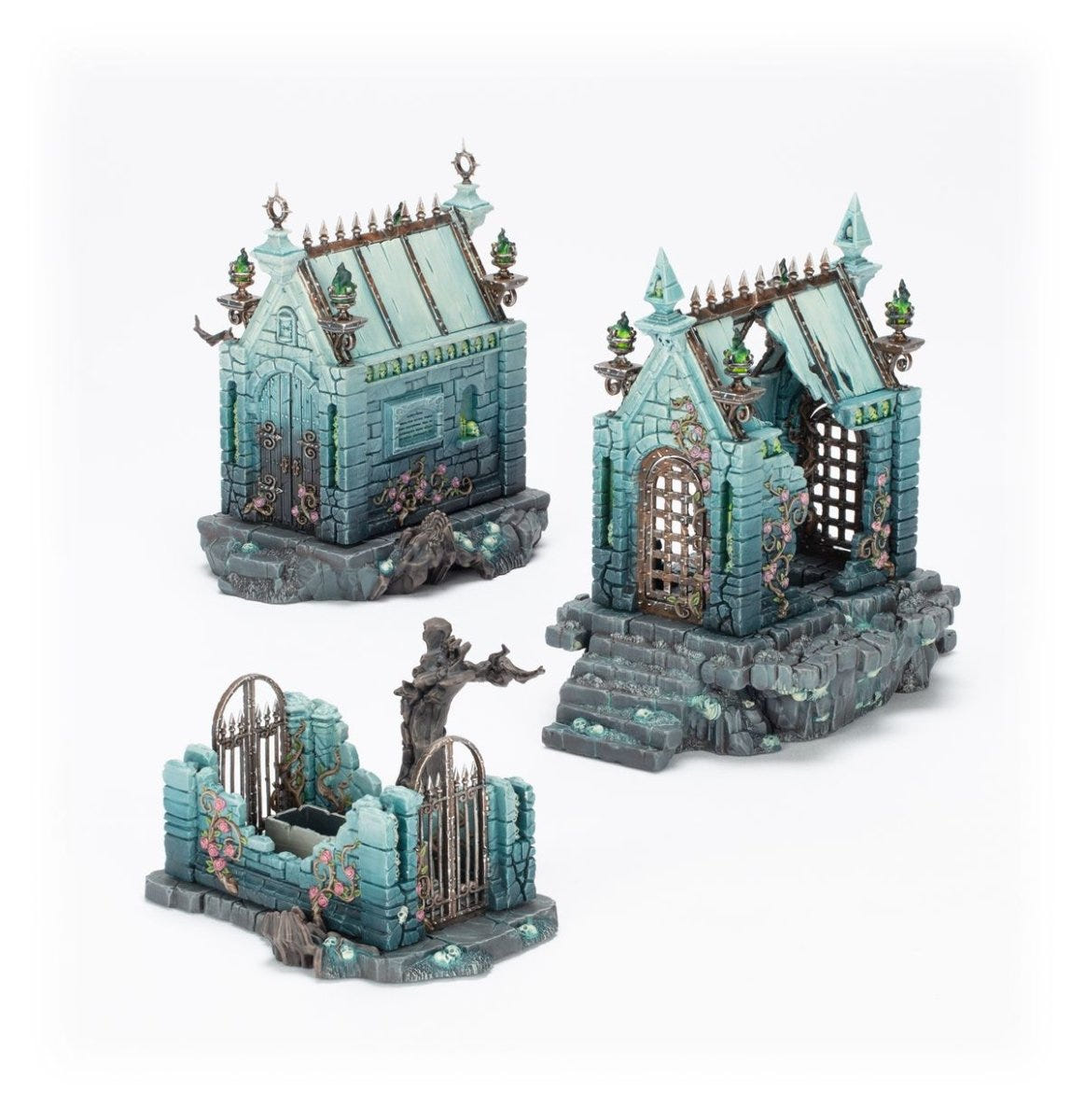 Cursed Sepulchre terrain painted in pale teal stone with a twisted tree and iron-gated crypt