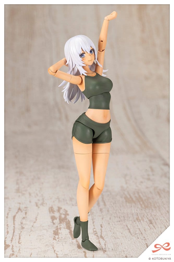 Training Wolf model kit posed with one arm raised in green crop top and shorts