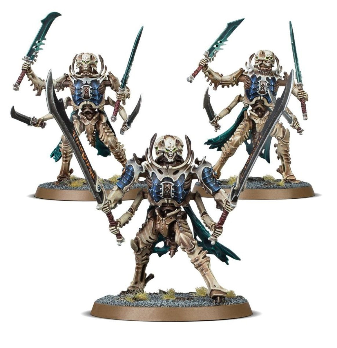 Three painted Ossiarch Bonereapers multi-armed bone warriors wielding curved blades
