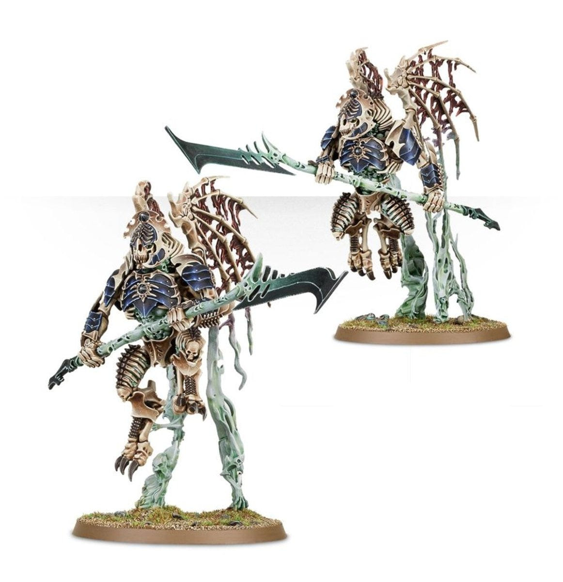 Two painted Ossiarch Bonereapers bone constructs with long glaives on spectral bases