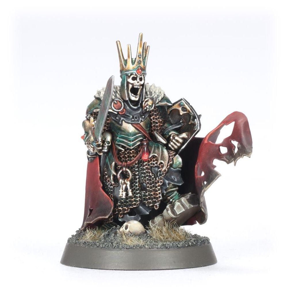 Painted crowned skeleton leader with sword and tattered red cloak from the Deathrattle Tomb Host