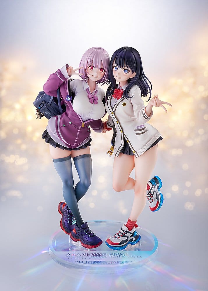 Rikka and Akane 1/7 figures on a shared clear base against a sparkling bokeh backdrop