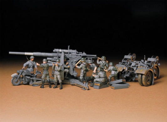 Tamiya 1/35 German 88mm Flak 36/37 kit, built gun, motorcycles and crew figures on a brown backdrop