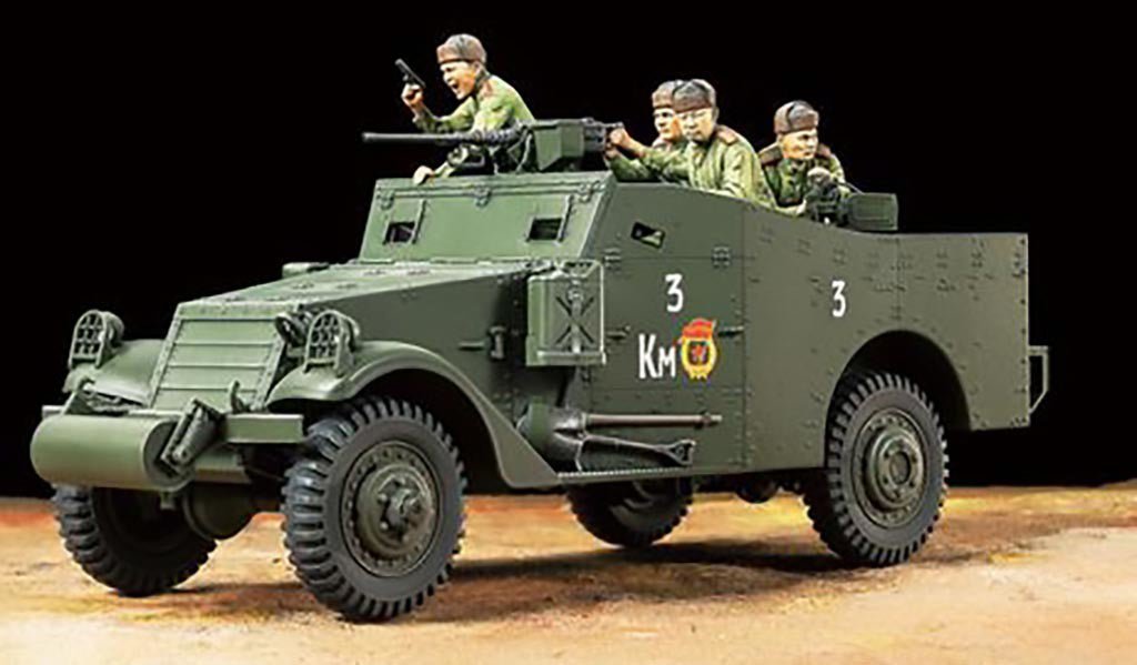 Tamiya 1/35 M3A1 Scout Car kit, built model with crew figures on a dark background