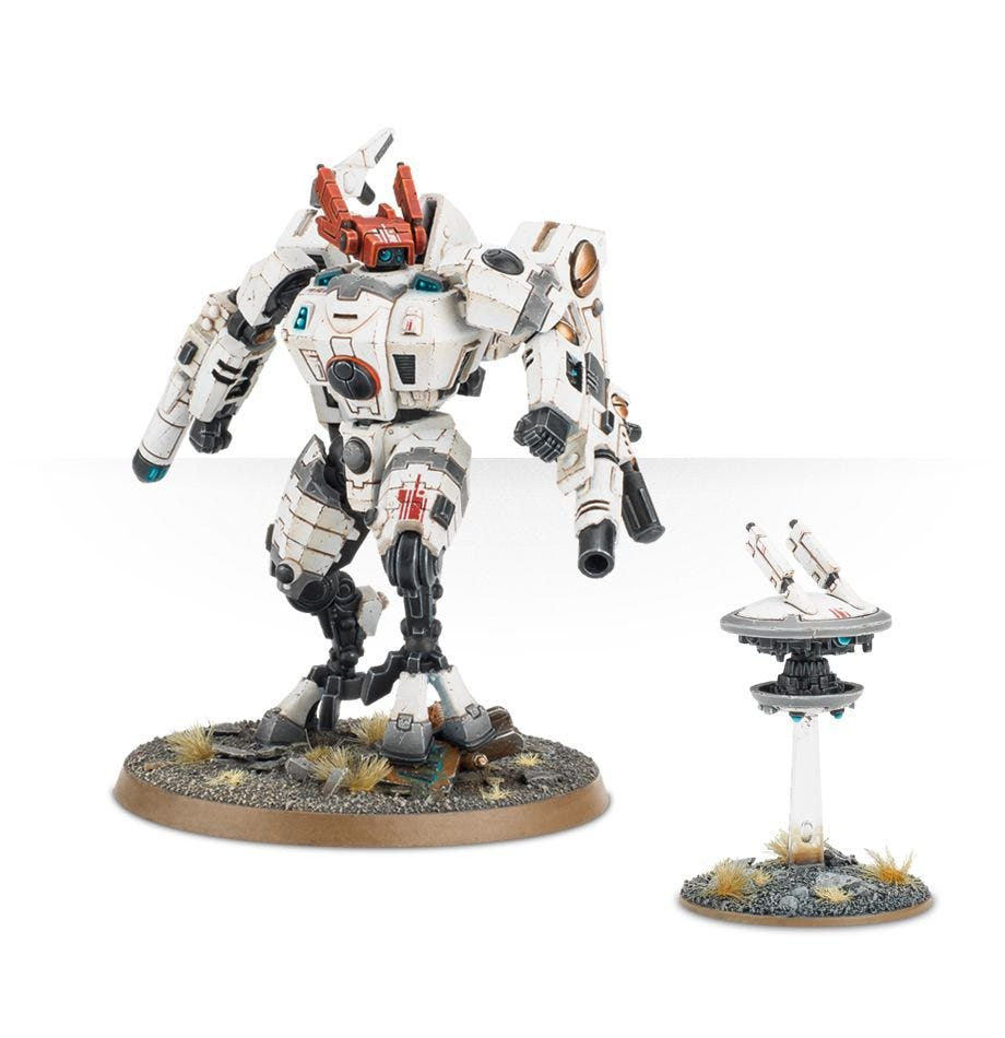 T'au Empire Commander in an alternative build with arm guns, beside a drone on its flight stand
