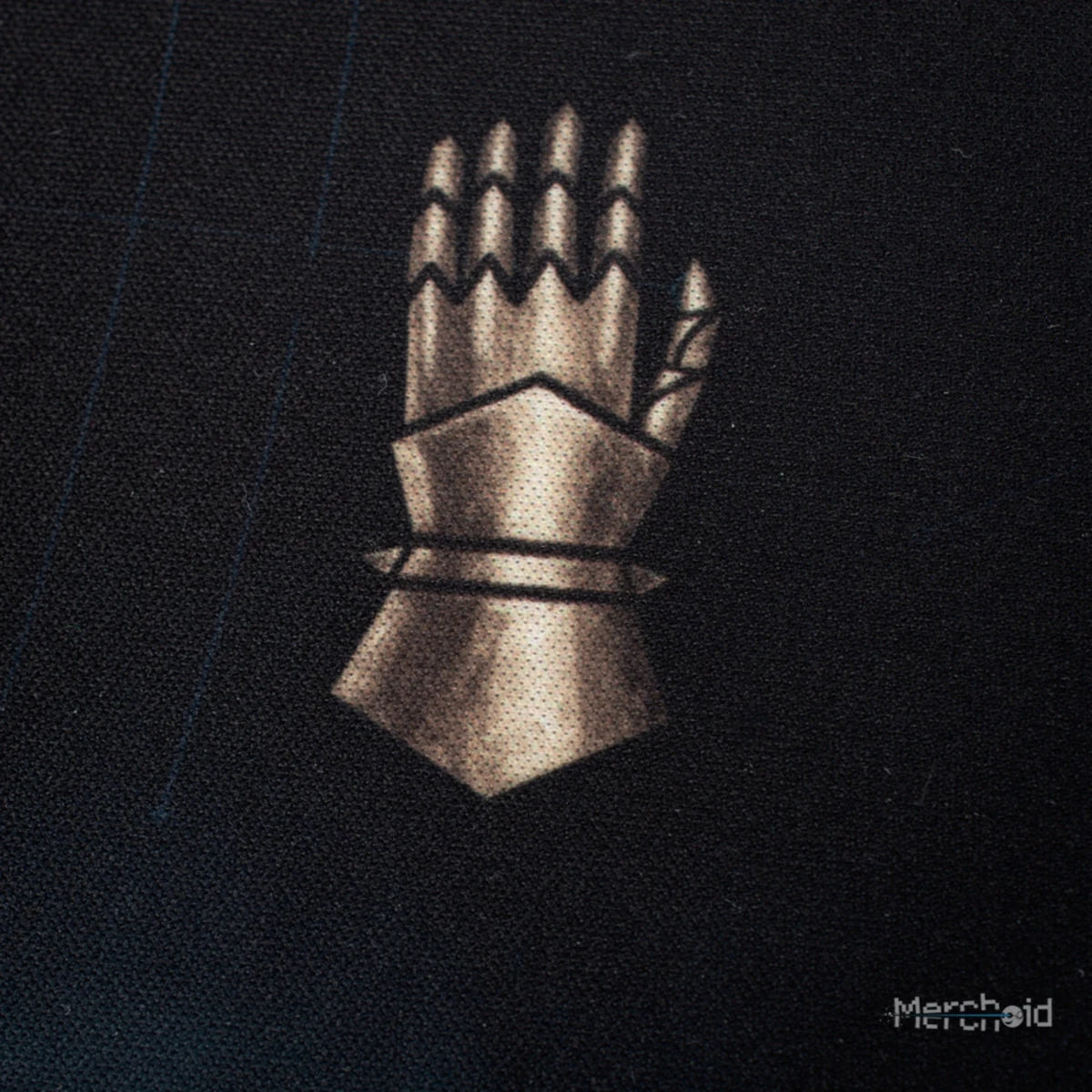Close-up of the desk mat's gauntlet Legion symbol on dark fabric