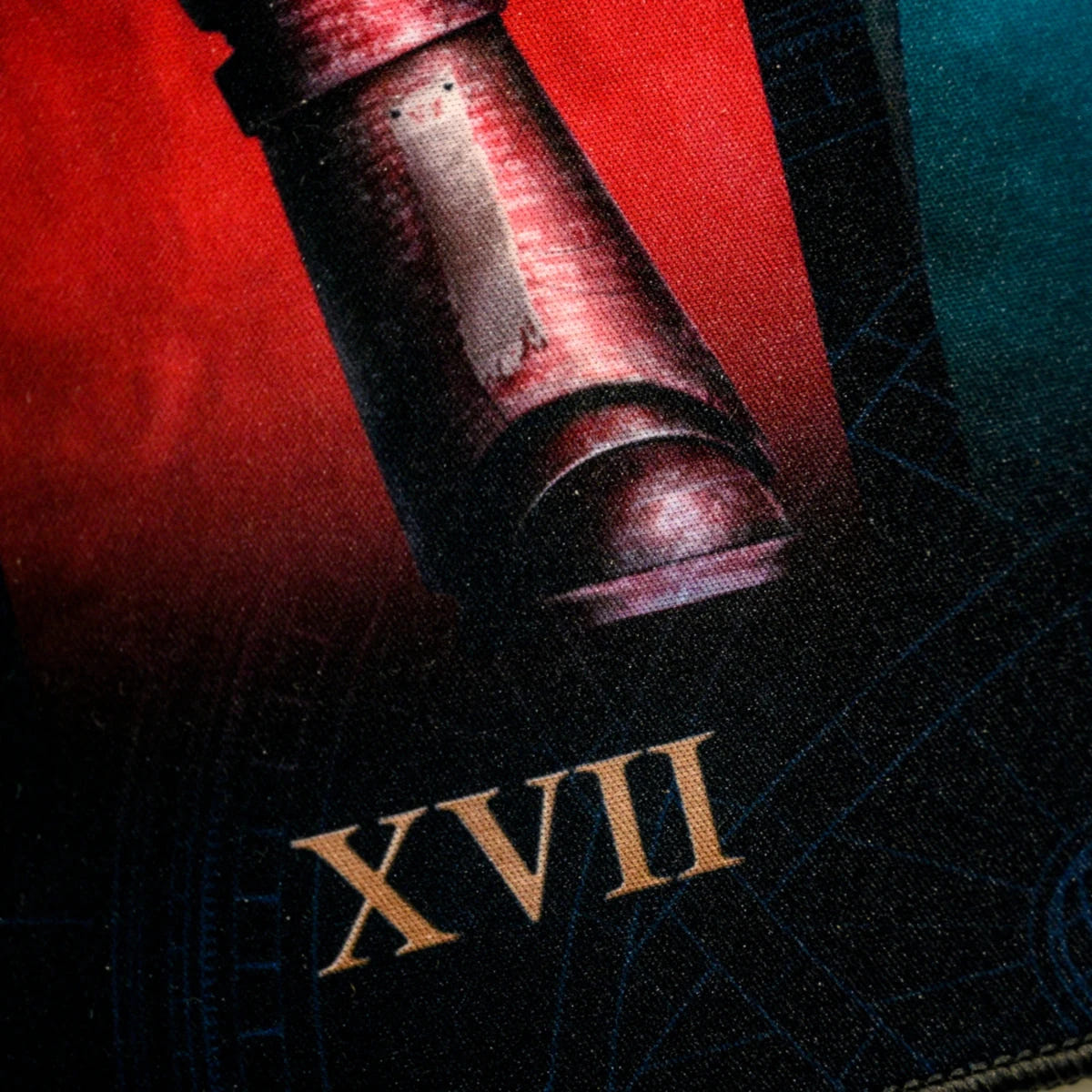 Close-up of Legion numeral XVII beneath a red armoured figure on the Horus Heresy desk mat