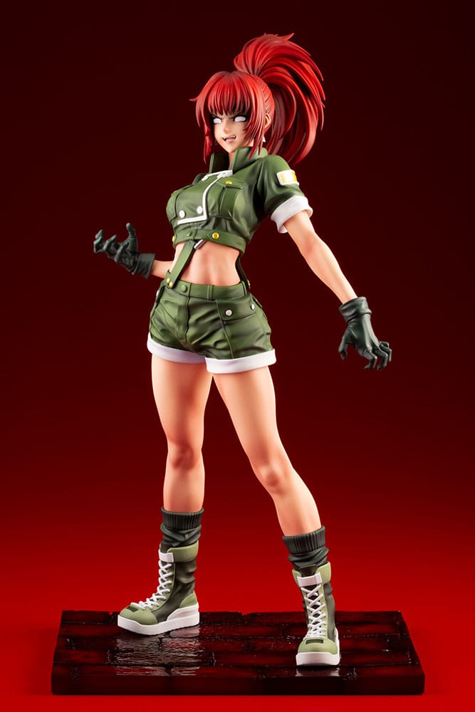 Orochi Leona 1/7 Bishoujo statue with crimson ponytail and gloved hands, front view on red backdrop