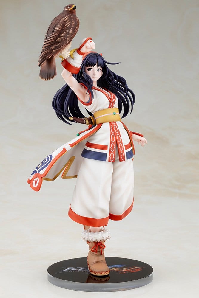 Front view of the Nakoruru figure in white and red Ainu-style outfit on a round base