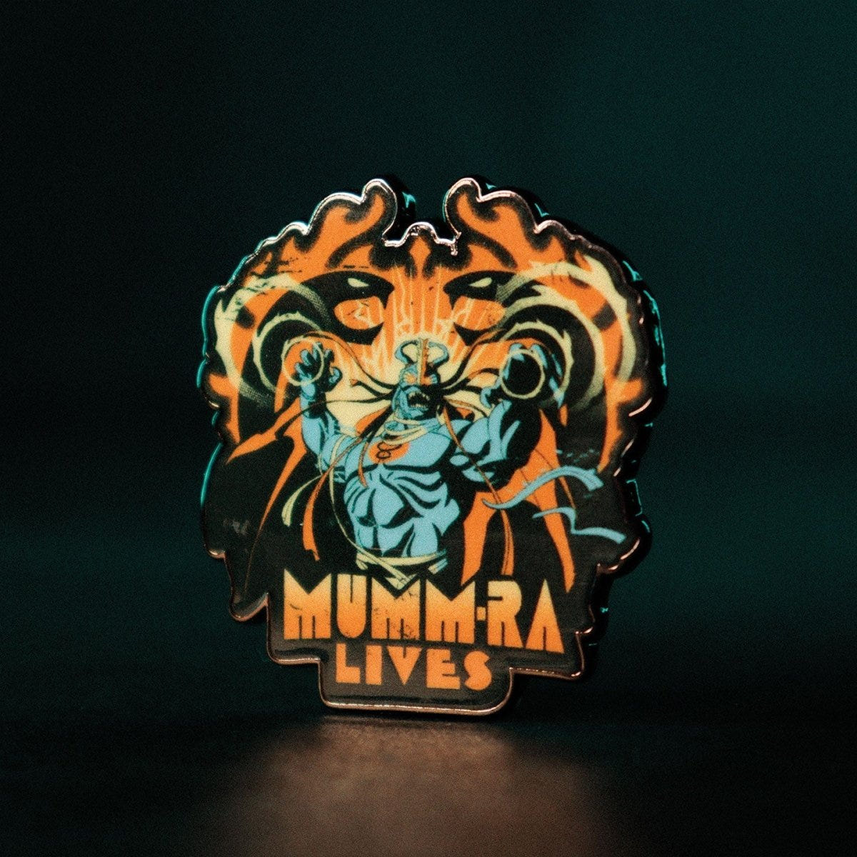 ThunderCats Mumm-Ra Lives enamel pin badge standing upright against a dark green backdrop