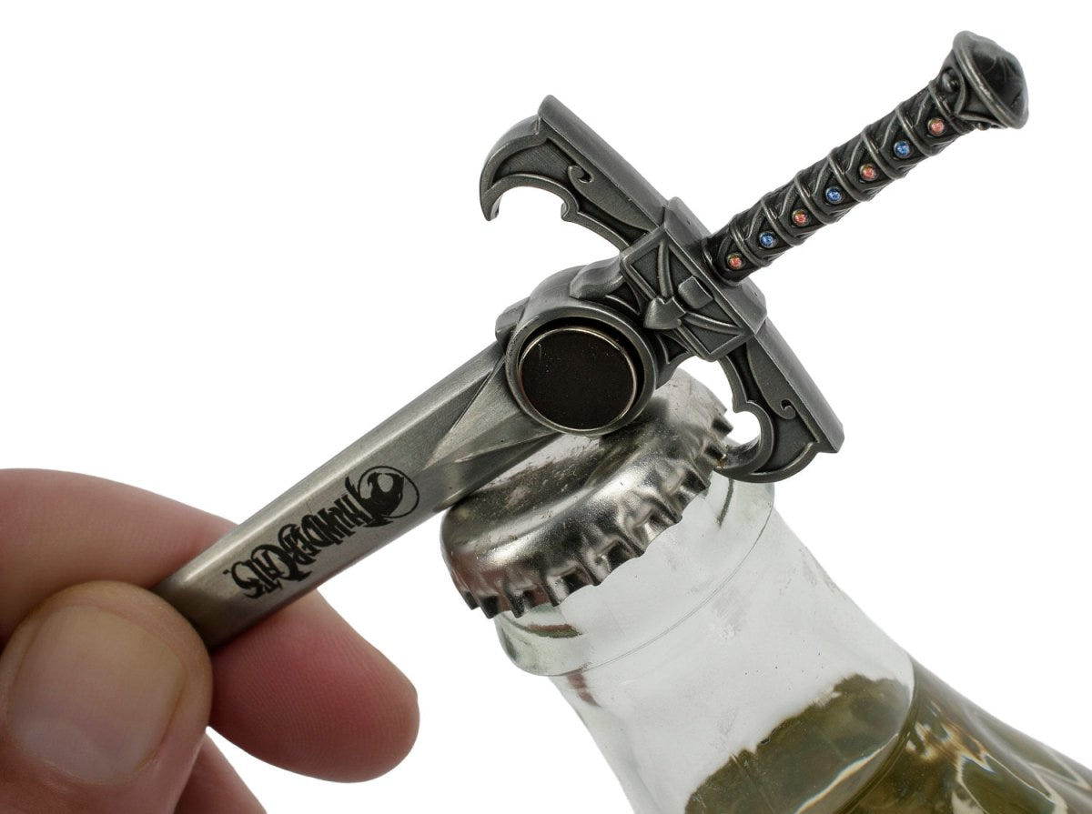 Hand using the Sword of Omens bottle opener on a glass bottle
