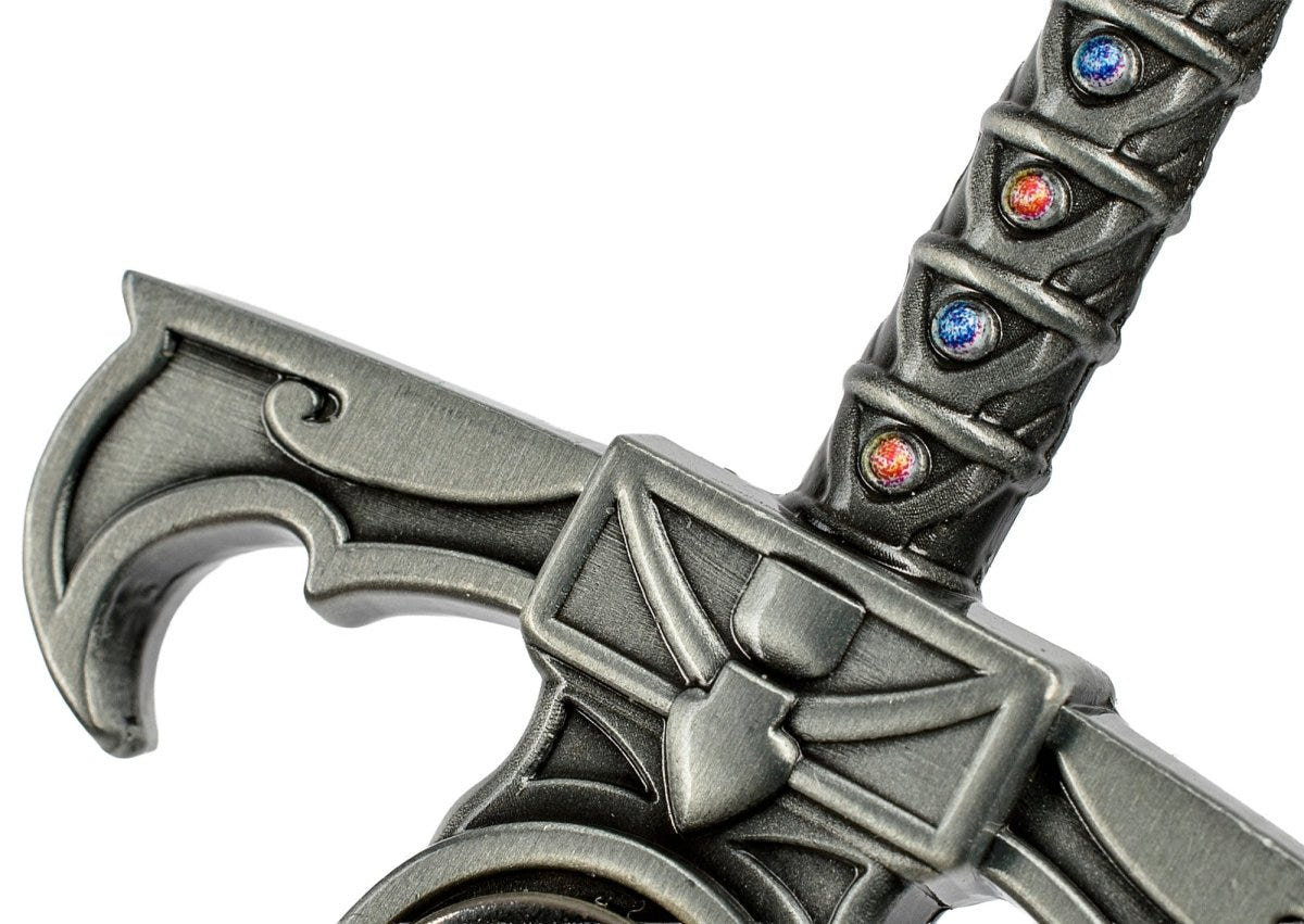 Close-up of the sculpted cross-guard and jewelled grip of the Sword of Omens bottle opener