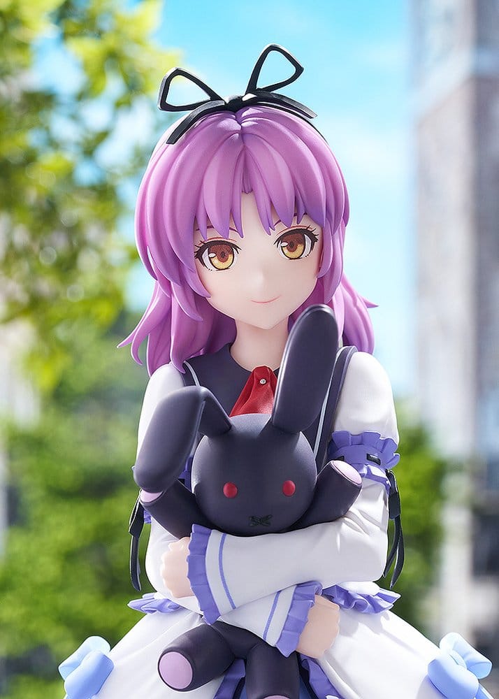 Close-up of Renne figure's face, purple hair, black ribbon and rabbit plush on a street backdrop
