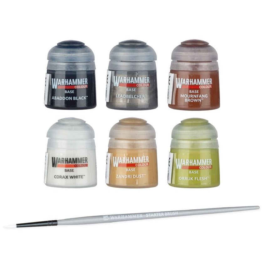 Six Warhammer 40k base paint bottles in a 2x3 grid above a single fine-detail brush, on a plain white background. The bottles show shades of black, gray, brown, white, beige, and green.