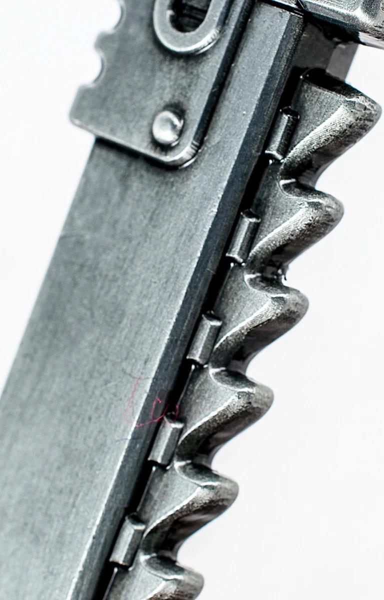 Close-up of the chainsword teeth along the bottle opener blade