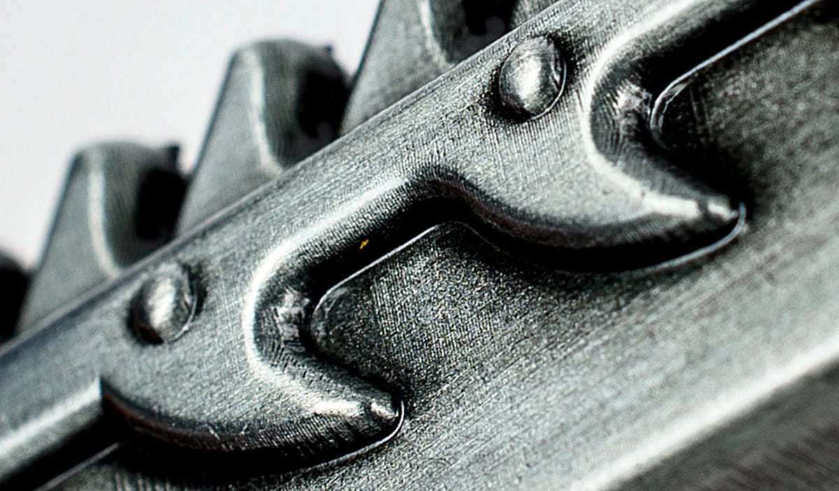 Macro close-up of the spiked chain teeth on the Chaos chainsword bottle opener