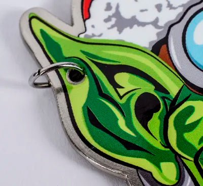 Close-up of the pointed green ear and metal edge of the Da Red Gobbo bottle opener