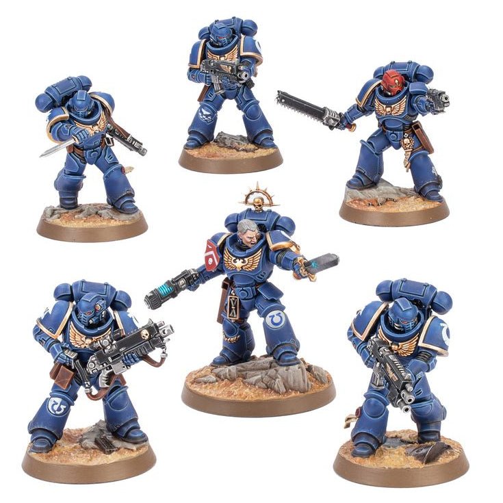 Six painted miniature warrior figures in blue armor with gold trim and some red accents, each mounted on a round textured base, shown on a plain white background.