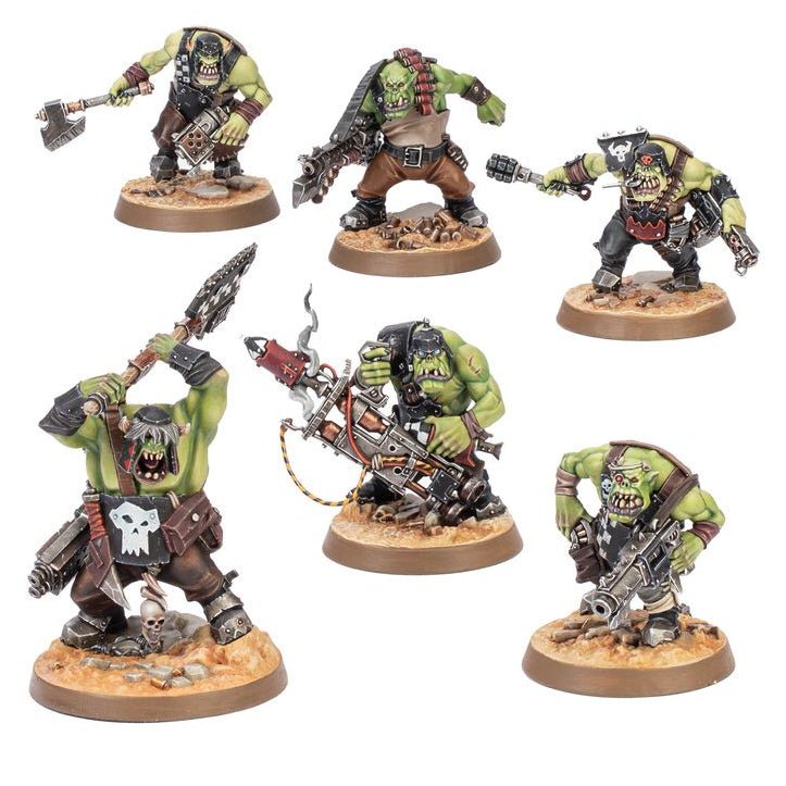 Five painted fantasy warrior miniatures on round brown bases, shown against a plain white background. The figures are green-skinned and heavily armored, with weapons including axes, chainsaws, and rifles.