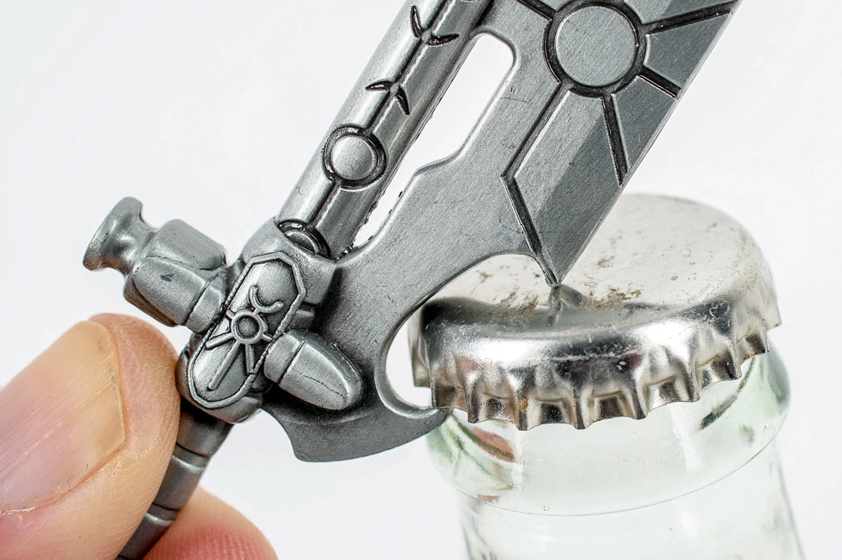 Necron Hyperphase Sword bottle opener hooked under a bottle cap, close-up in use