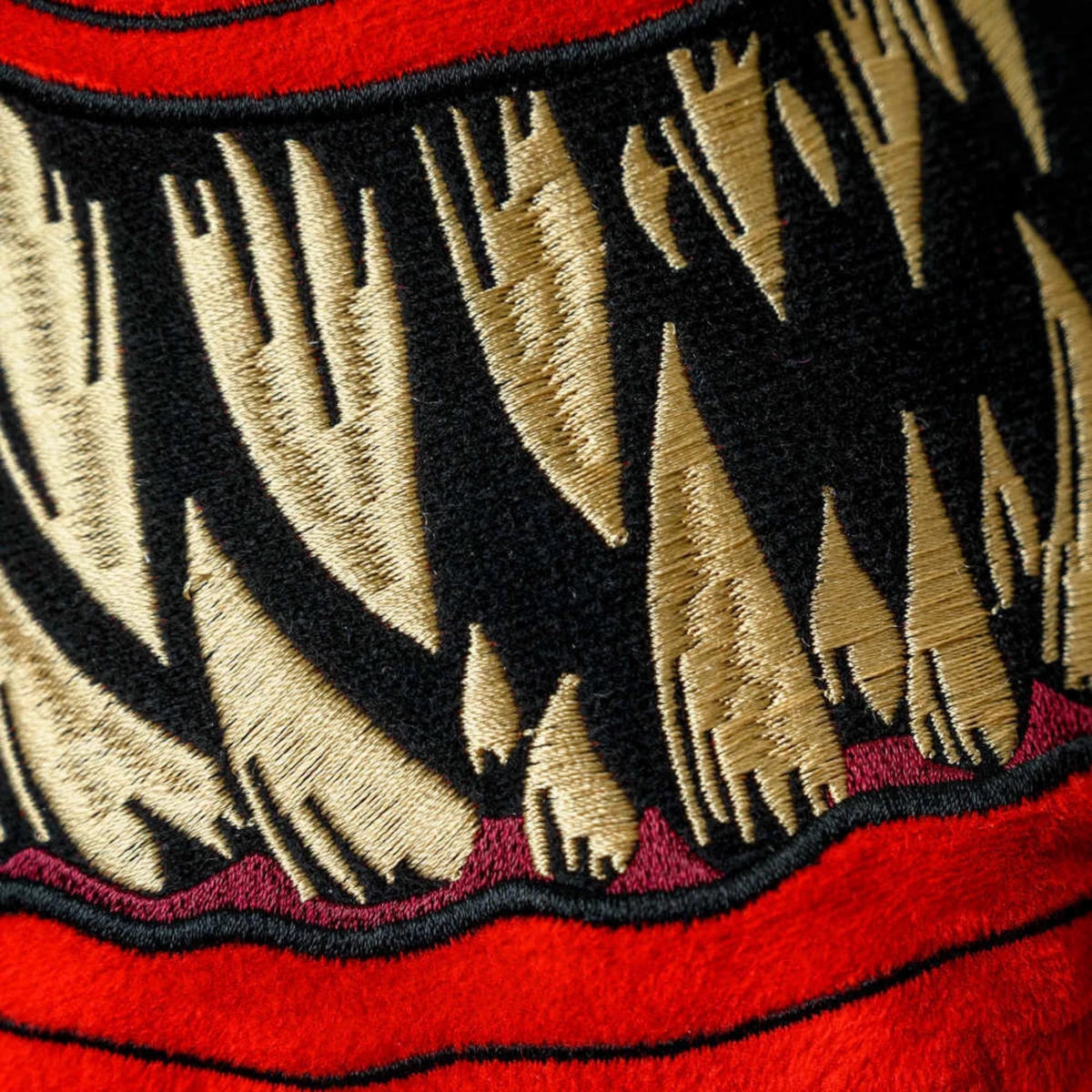 Close-up of the embroidered fangs on the Warhammer Red Squig slippers
