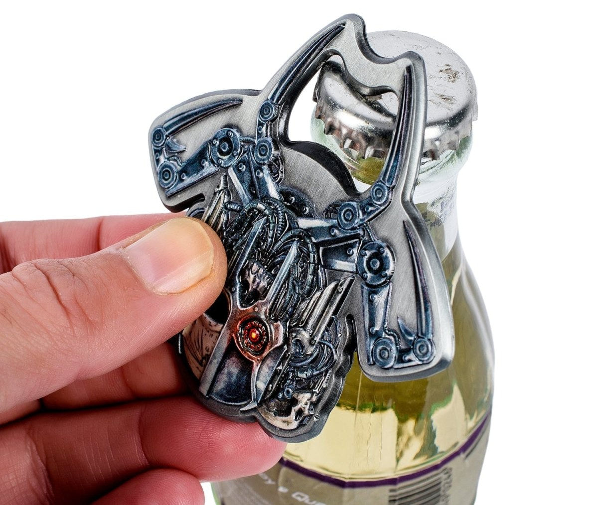 Hand using the Servo Skull bottle opener to open a glass bottle