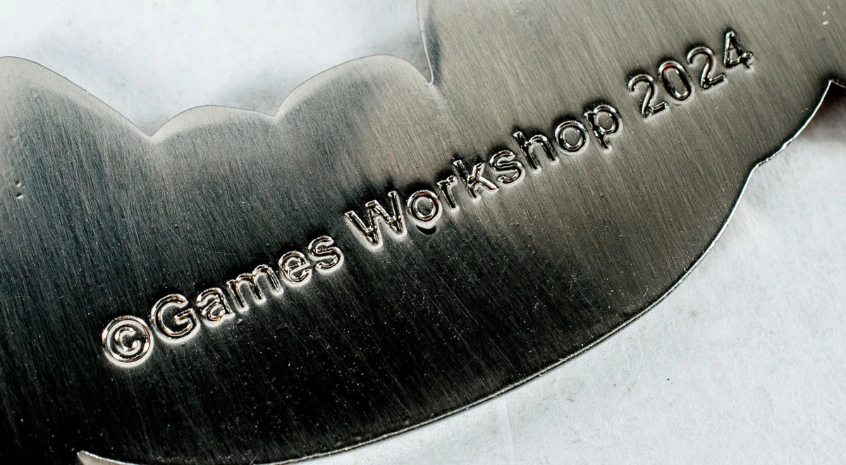 Close-up of the Games Workshop 2024 copyright engraving on the Squig bottle opener