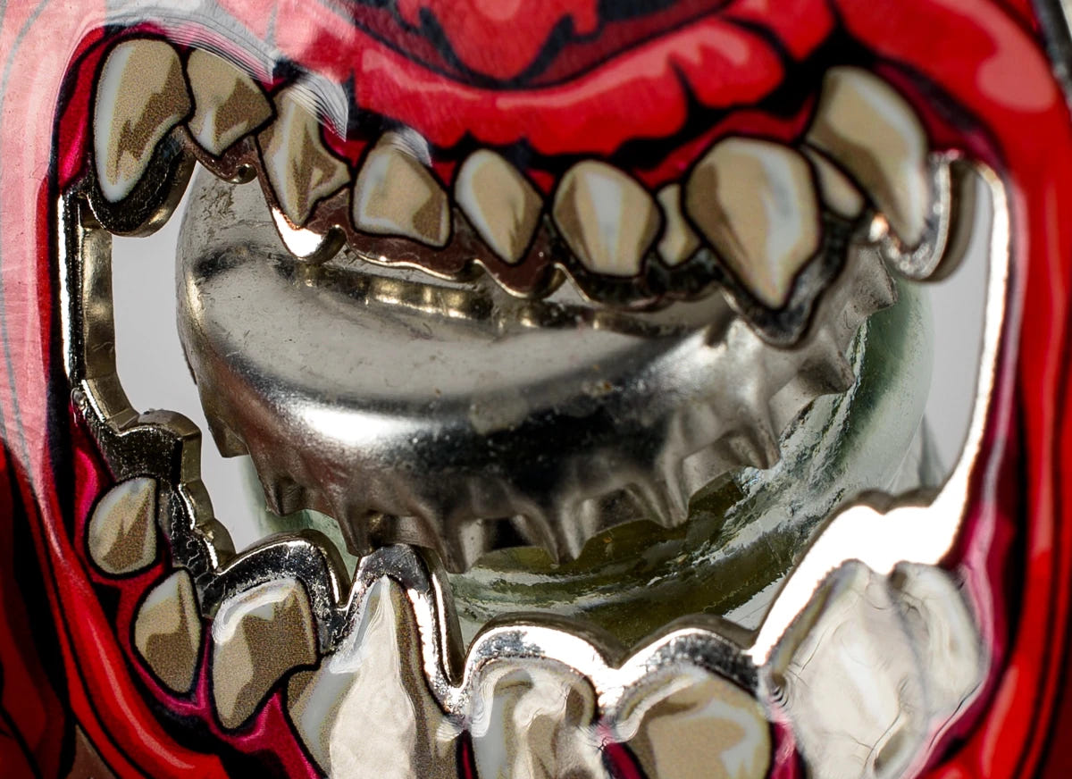 Close-up of the Squig bottle opener's teeth hooked around a bottle cap